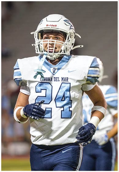 A football player wearing a blue jersey with the number 58 on it. Description generated by AI