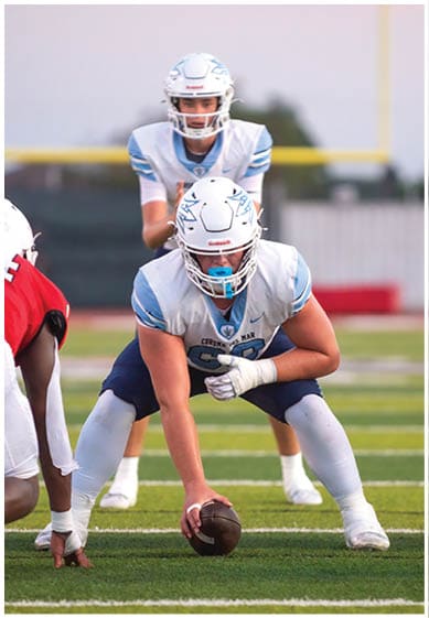 A football player wearing a blue jersey with the number 58 on it. Description generated by AI