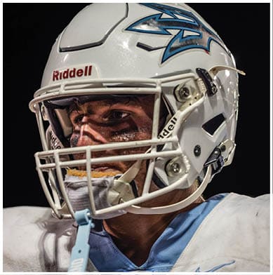 A football player running on the field. Description generated by AI