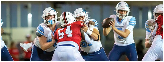 A football player is sliding on the ground. Description generated by AI