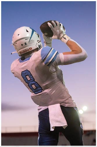 A football player running on the field. Description generated by AI