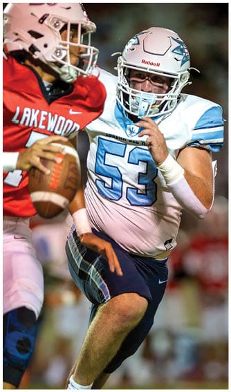 A football player running on the field. Description generated by AI