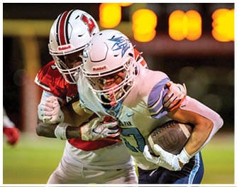 A football player is sliding on the ground. Description generated by AI