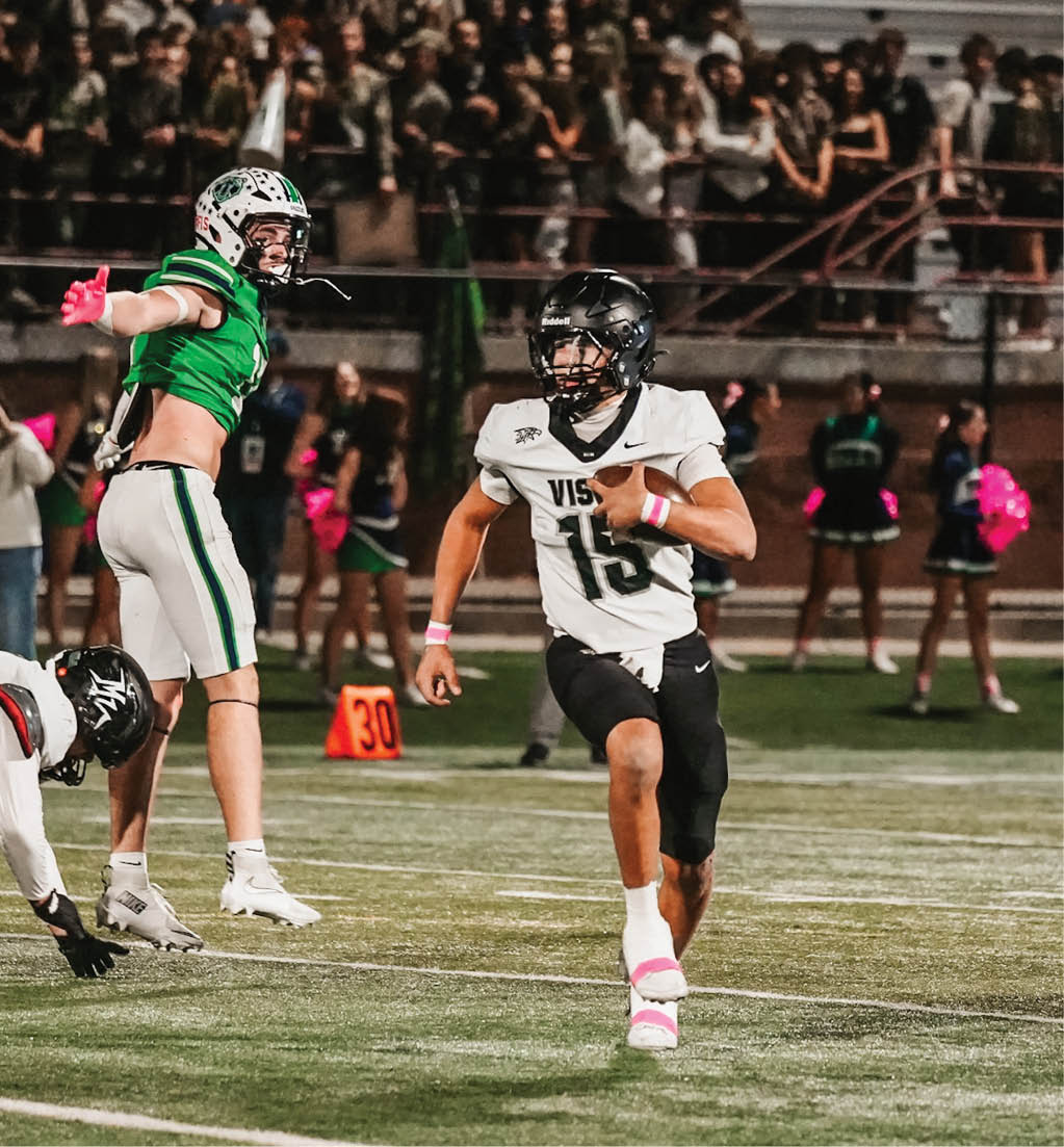 A football player running with a football. Description generated by AI