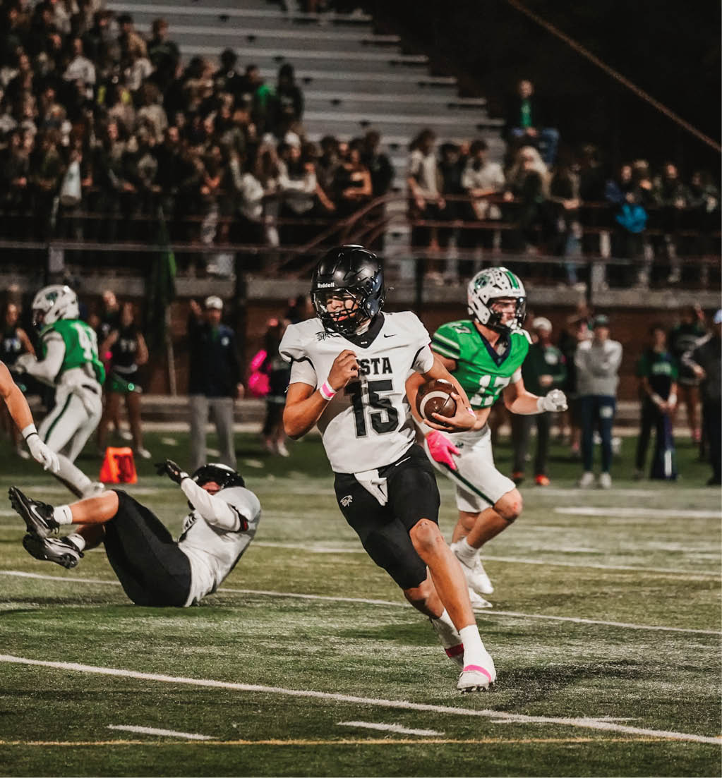 A football player running with a football. Description generated by AI