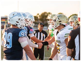 A group of football players on a field. Description generated by AI