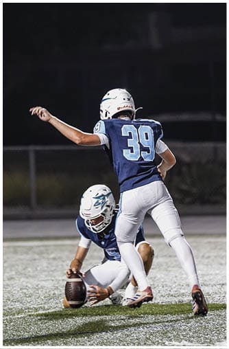 A football player running on the field. Description generated by AI