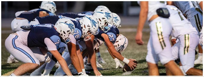 A football player is sliding on the ground. Description generated by AI