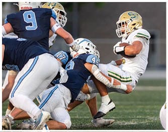 A football player is sliding on the ground. Description generated by AI