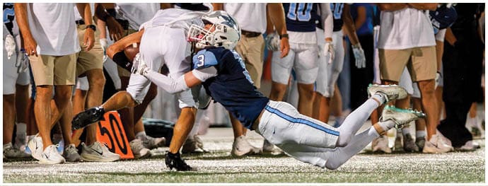 A football player is sliding on the ground. Description generated by AI