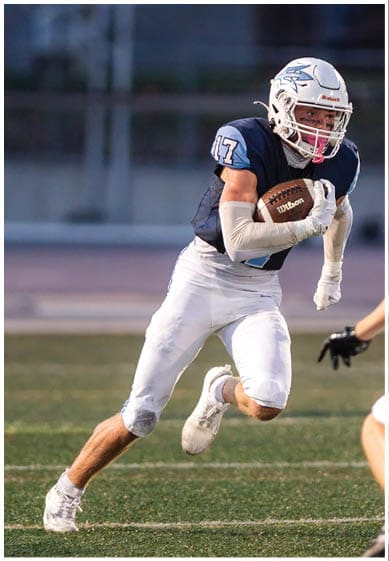 A football player wearing a blue jersey with the number 58 on it. Description generated by AI