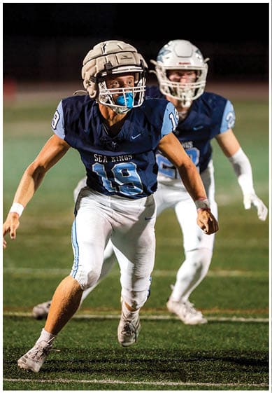 A football player wearing a blue jersey with the number 58 on it. Description generated by AI