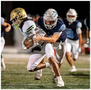 A football player wearing a blue jersey with the number 58 on it. Description generated by AI