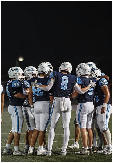 A football player wearing a blue jersey with the number 58 on it. Description generated by AI