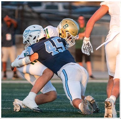 A football player wearing a blue jersey with the number 58 on it. Description generated by AI