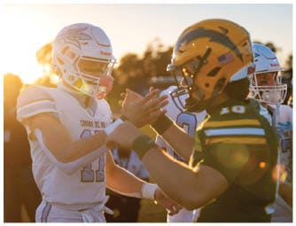 A group of football players on a field. Description generated by AI