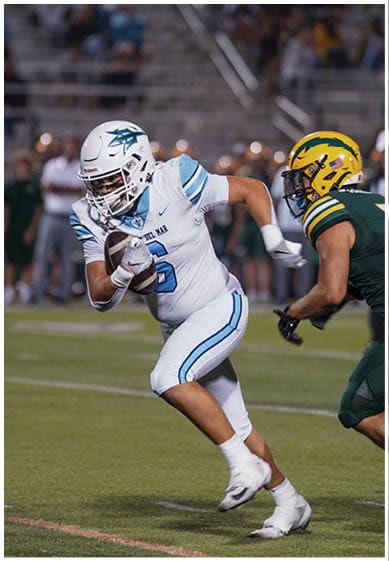 A football player wearing a blue jersey with the number 58 on it. Description generated by AI