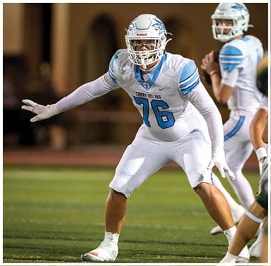 A football player wearing a blue jersey with the number 58 on it. Description generated by AI