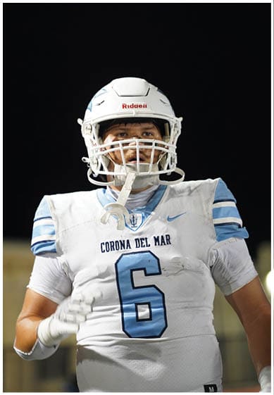 A football player wearing a blue jersey with the number 58 on it. Description generated by AI
