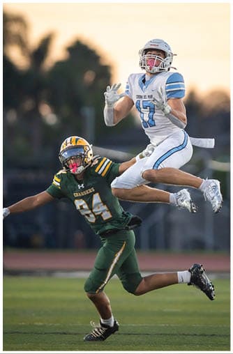 A football player running on the field. Description generated by AI