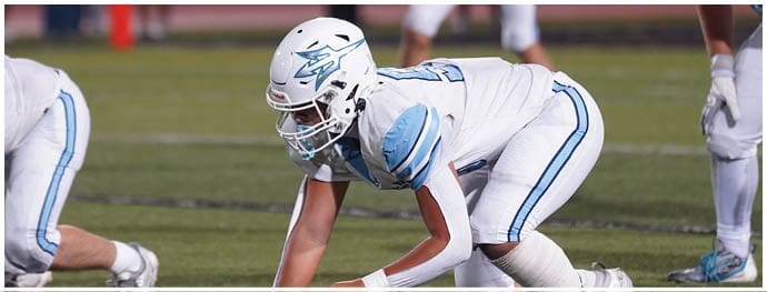 A football player is sliding on the ground. Description generated by AI
