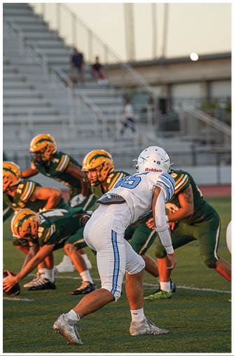 A football player running on the field. Description generated by AI