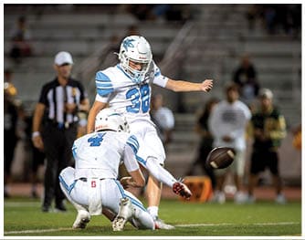A football player is sliding on the ground. Description generated by AI