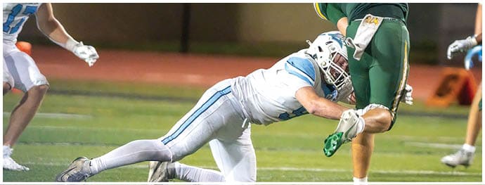 A football player is sliding on the ground. Description generated by AI