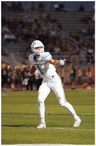 A football player running on the field. Description generated by AI