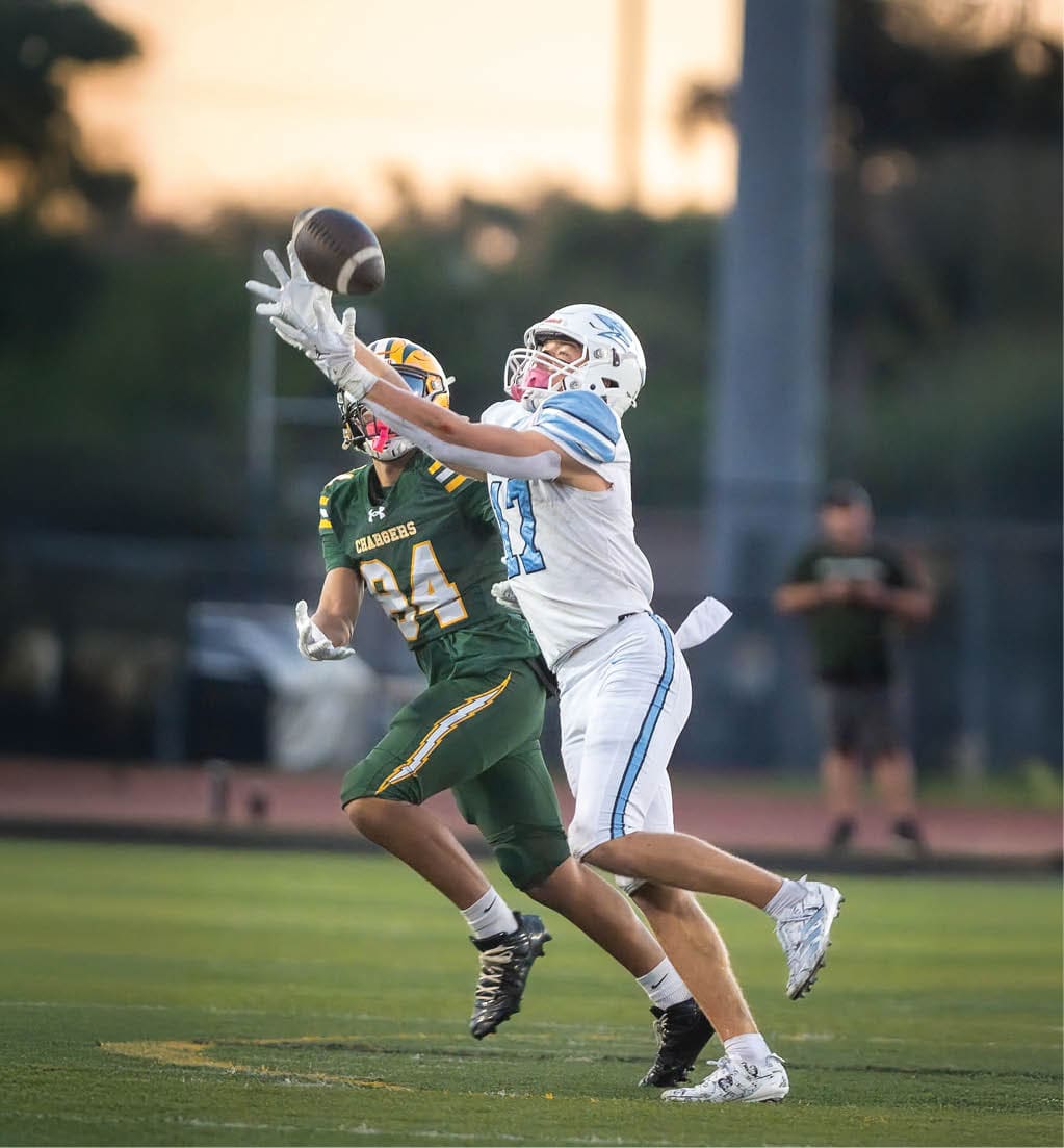 A football player in a white jersey with the number 16 on it. Description generated by AI