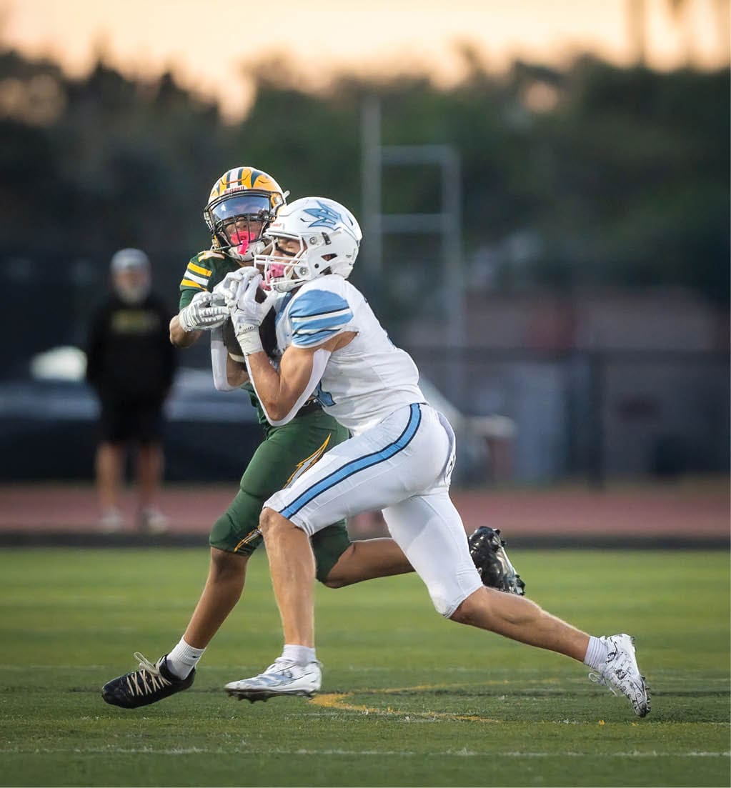 A football player running with a football. Description generated by AI