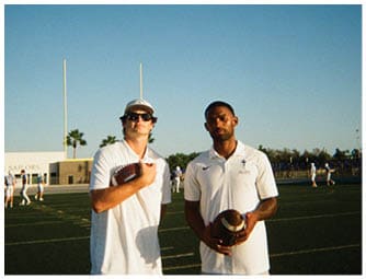 A group of football players on a field. Description generated by AI