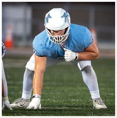 A football player running on the field. Description generated by AI