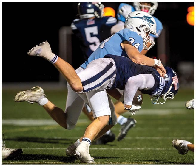 A football player wearing a blue jersey with the number 58 on it. Description generated by AI