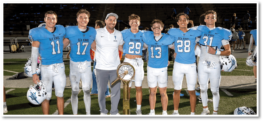 A group of football players on a field. Description generated by AI