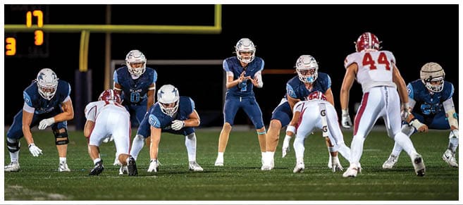 A football player wearing a blue jersey with the number 58 on it. Description generated by AI