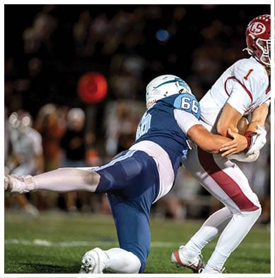 A football player running on the field. Description generated by AI