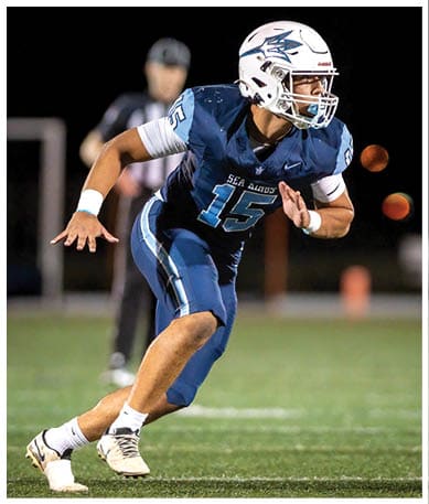 A football player wearing a blue jersey with the number 58 on it. Description generated by AI