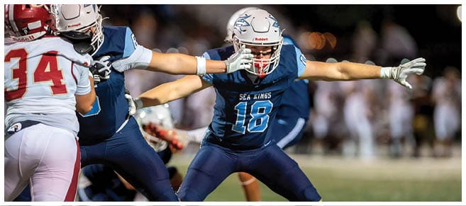 A football player wearing a blue jersey with the number 58 on it. Description generated by AI