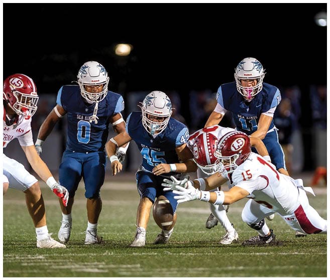 A football player wearing a blue jersey with the number 58 on it. Description generated by AI