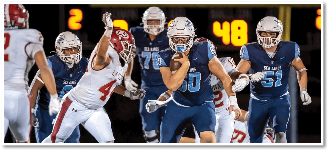 A group of football players on a field. Description generated by AI