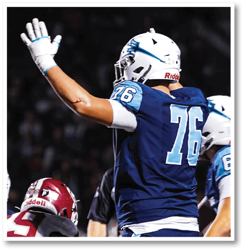 A football player wearing a black jersey with the number 6 on it. Description generated by AI