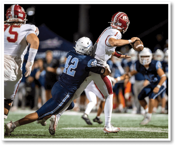 A football player is kicking a football on a field. Description generated by AI