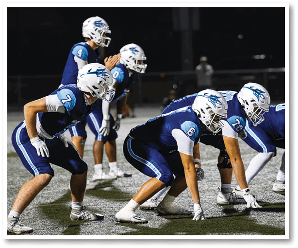 A group of football players wearing black jerseys with the number 3 on them. Description generated by AI