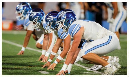 A football player wearing a blue jersey with the number 58 on it. Description generated by AI