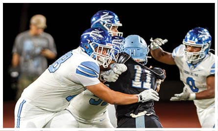 A football player wearing a blue jersey with the number 58 on it. Description generated by AI