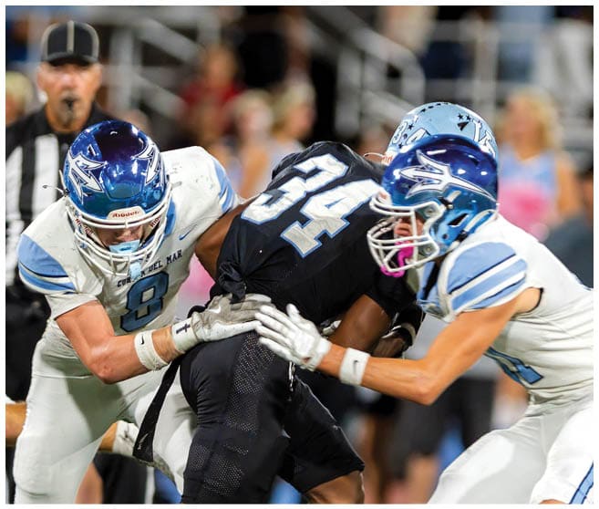 A football player wearing a blue jersey with the number 58 on it. Description generated by AI