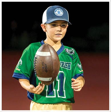 A football player running on the field. Description generated by AI