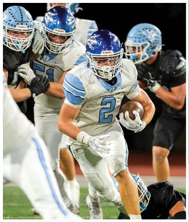 A football player wearing a blue jersey with the number 58 on it. Description generated by AI