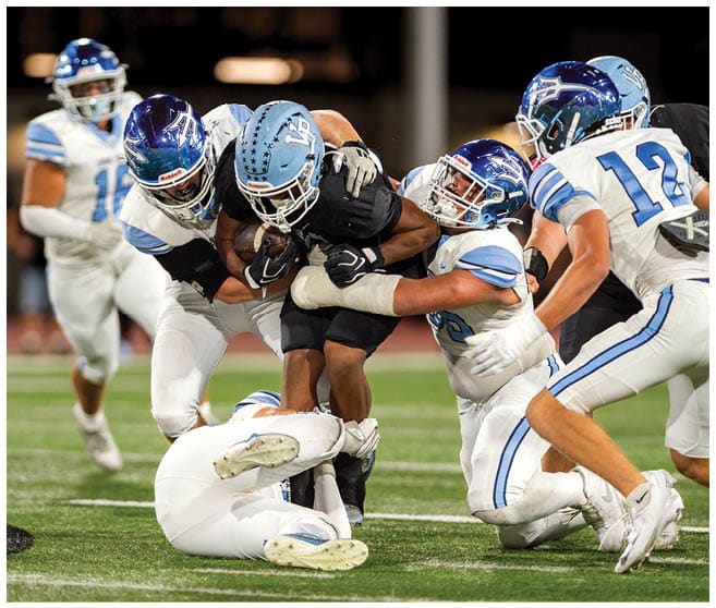 A football player wearing a blue jersey with the number 58 on it. Description generated by AI